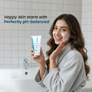 Woman applying Safrin Skin Care cleanser in bathroom, smiling, showcasing pH-balanced face wash