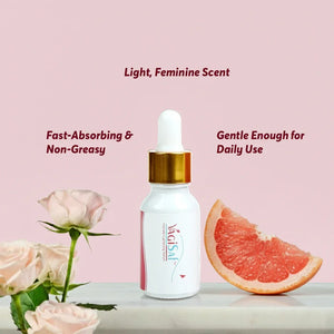 Safrin Skin Care serum bottle with gold dropper, roses, and grapefruit against pink background