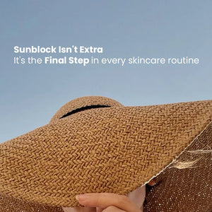 Woman in wide-brimmed straw hat under clear sky with text about sunblock as final skincare step