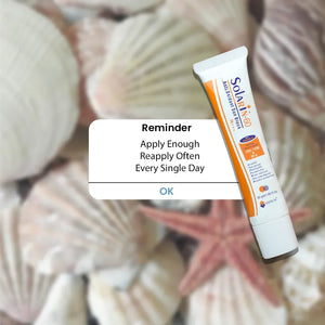 Safrin Skin Care Solarin-60 sunblock tube with application reminder, seashells background