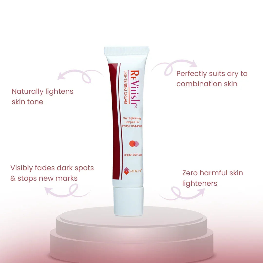 Safrin Revitish Lightening Cream tube on podium, fades dark spots, for dry to combination skin.